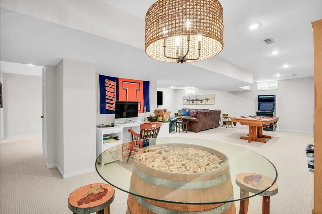 a view of a white house with a yard and sitting area