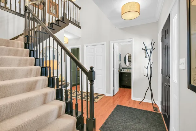 a dining room with furniture a chandelier and wooden floor