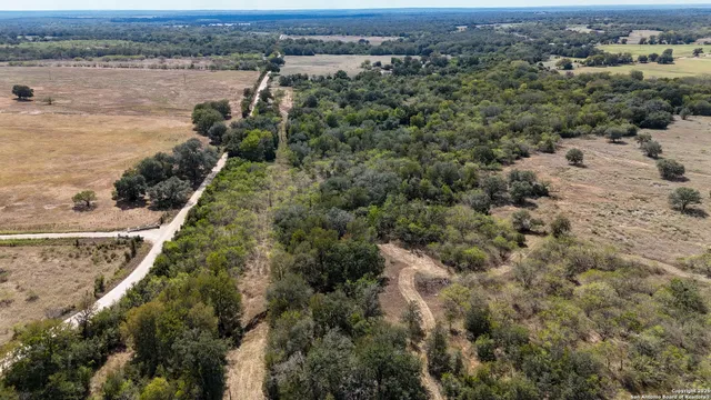 an aerial view of a houses with a lake view