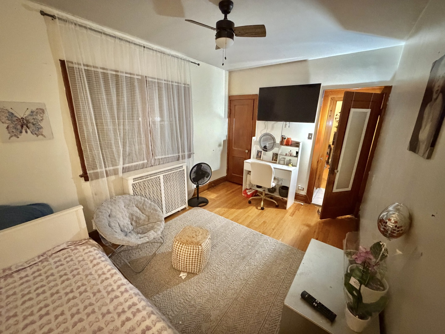 1917 Home Avenue Berwyn, IL 60402 - Photo 2 of 13 a bedroom with furniture and a flat tv screen