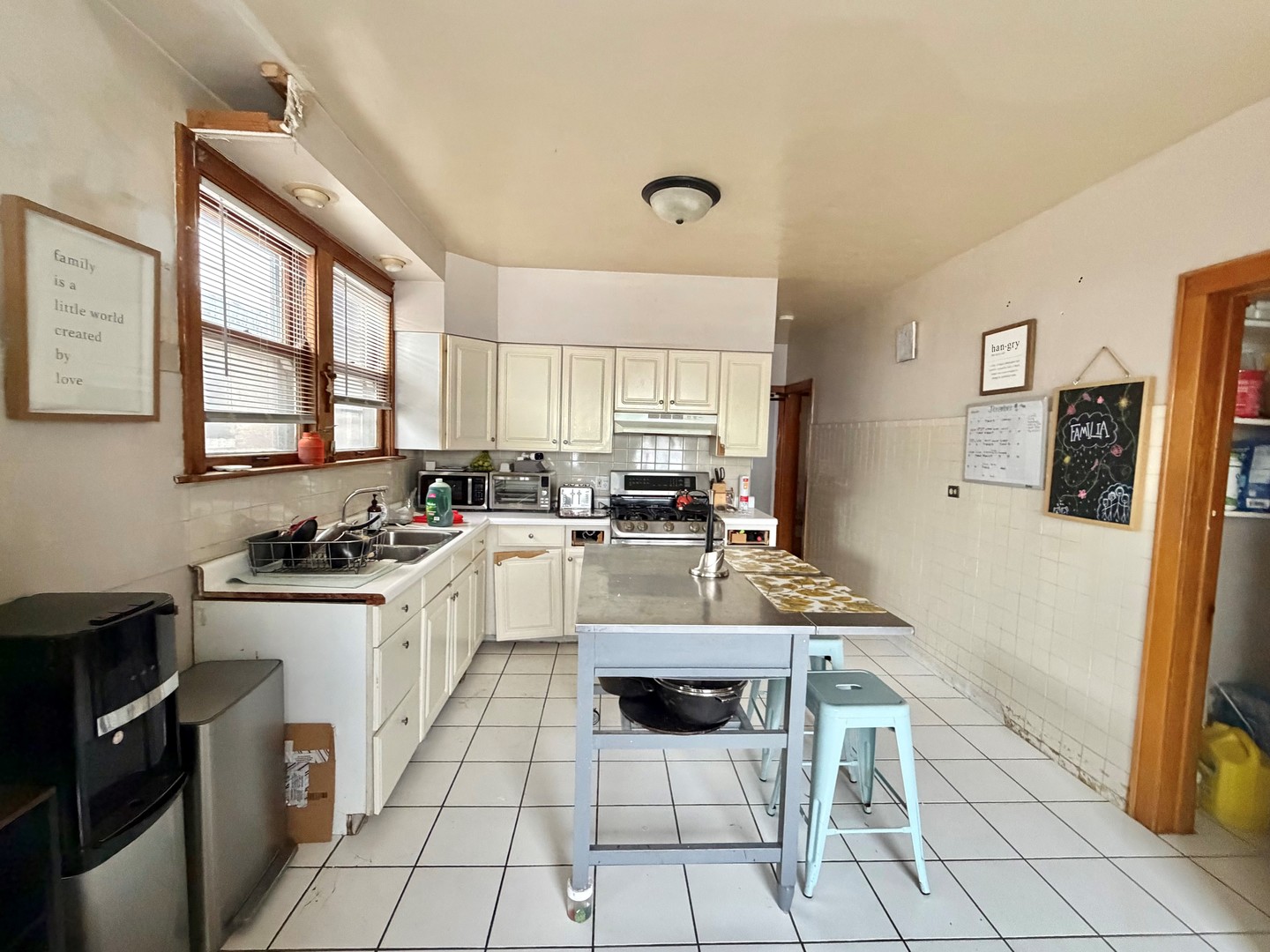 1917 Home Avenue Berwyn, IL 60402 - Photo 3 of 13 a kitchen with stainless steel appliances a stove a sink a microwave and a refrigerator