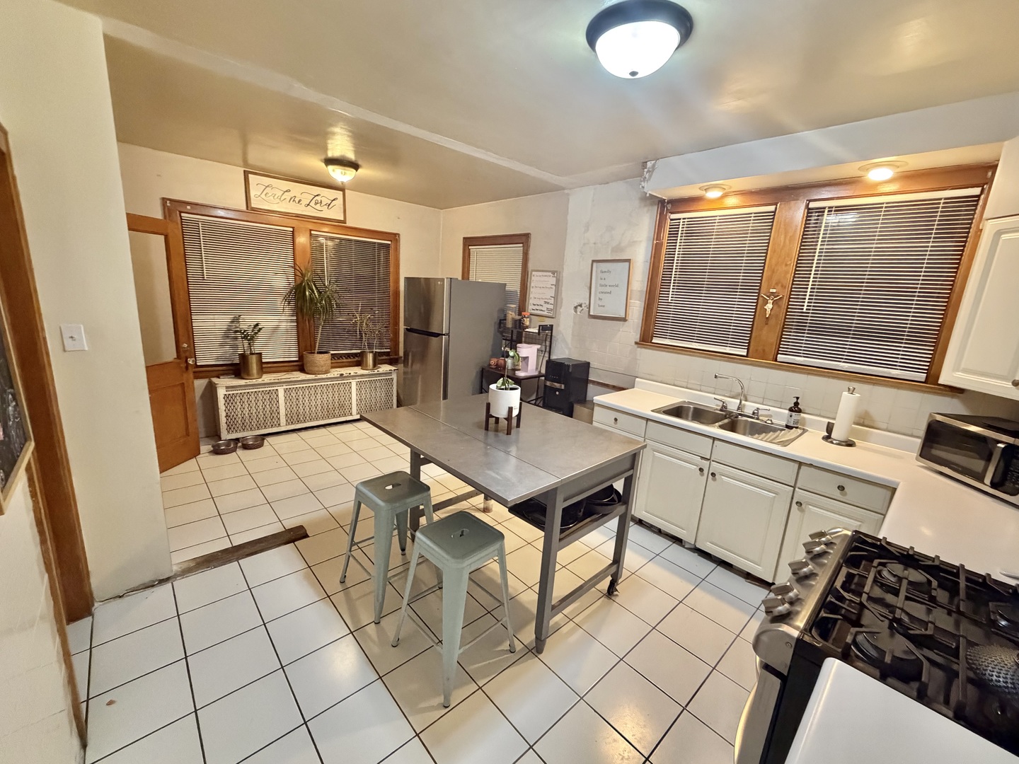 1917 Home Avenue Berwyn, IL 60402 - Photo 5 of 13 a living room with stainless steel appliances furniture a rug and a view of kitchen