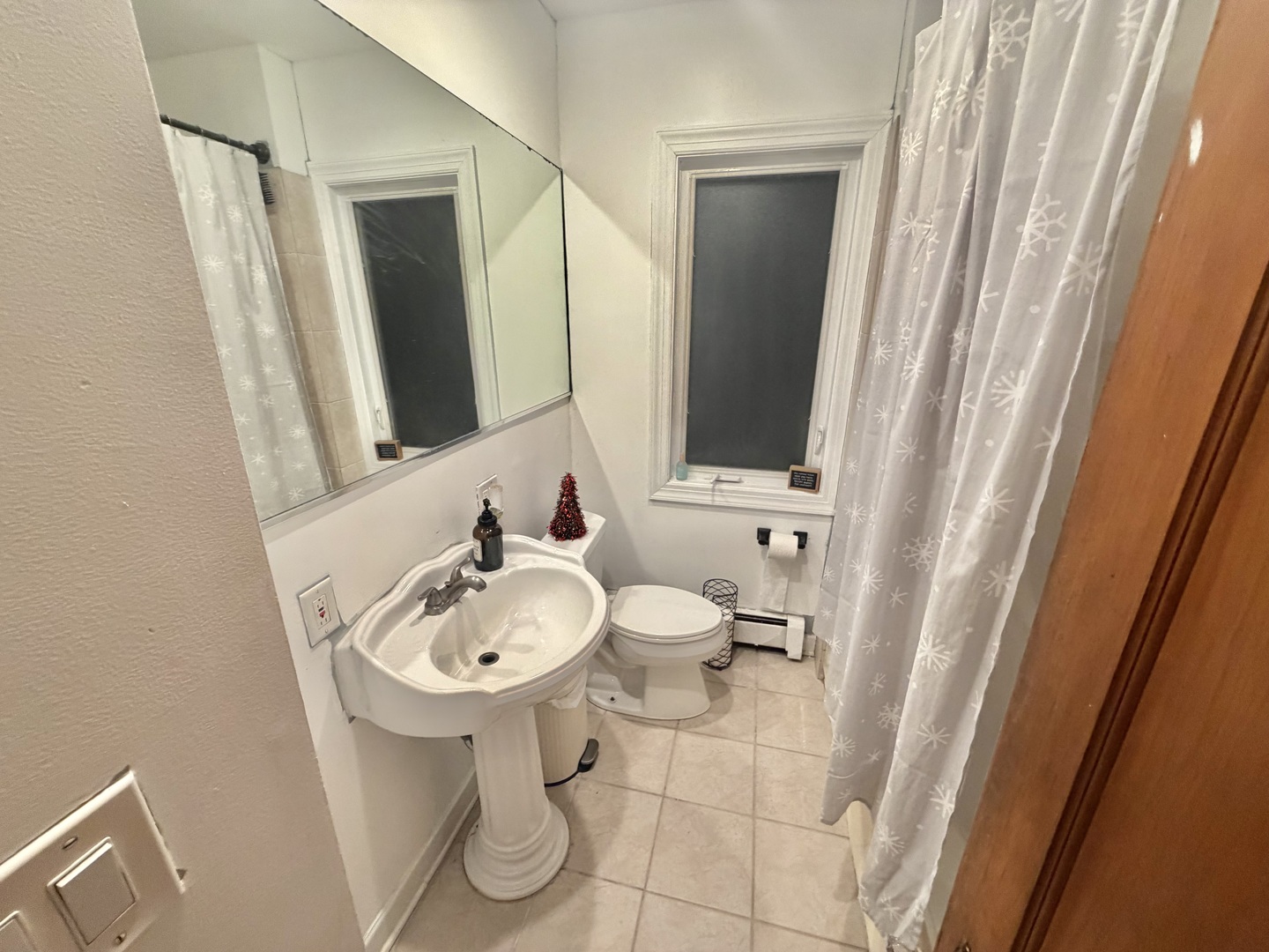 1917 Home Avenue Berwyn, IL 60402 - Photo 6 of 13 a bathroom with a sink a mirror and a shower