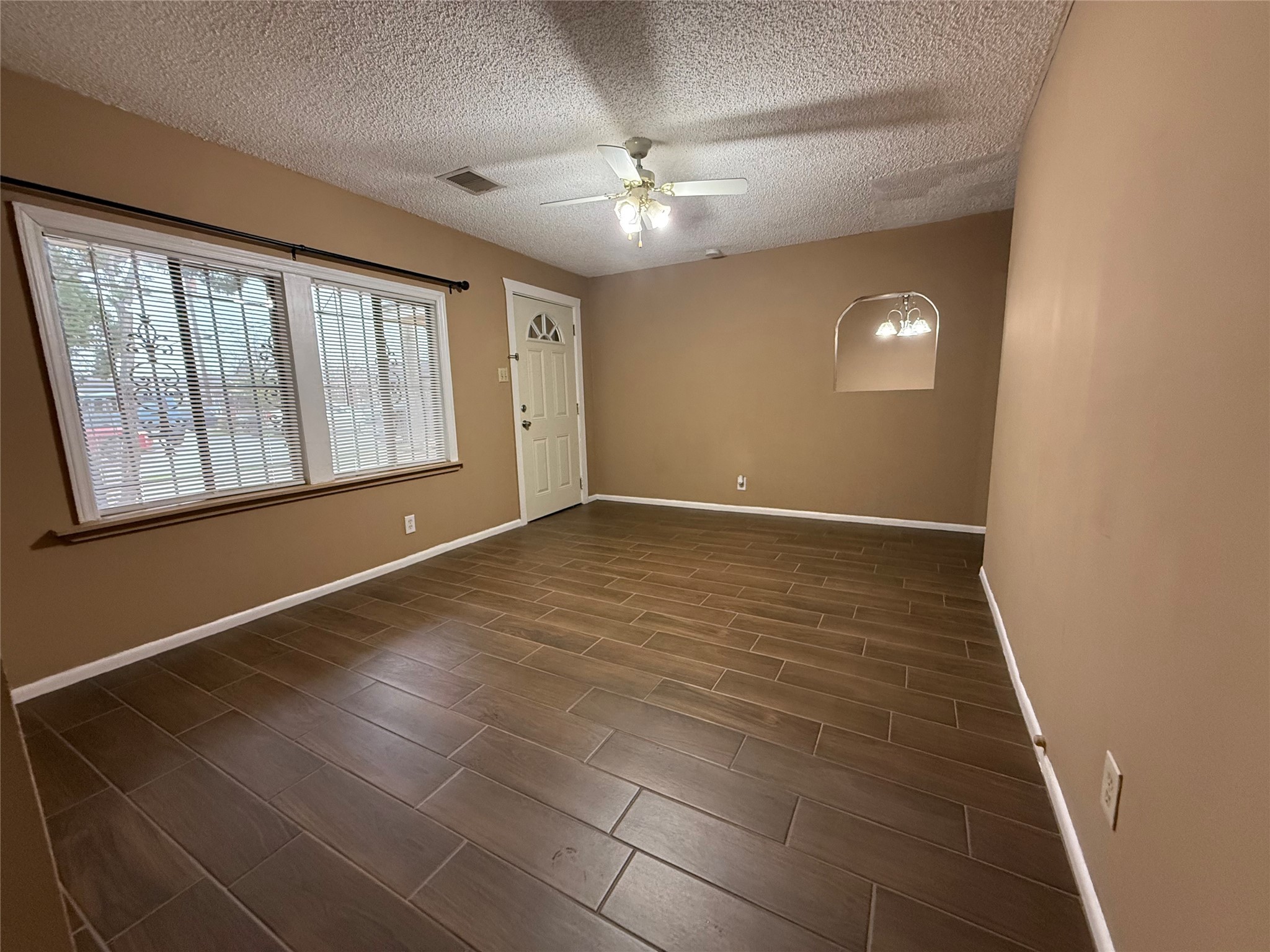 11216 Rusty Street Houston, TX 77093 - Photo 9 of 18 a view of an empty room with a window