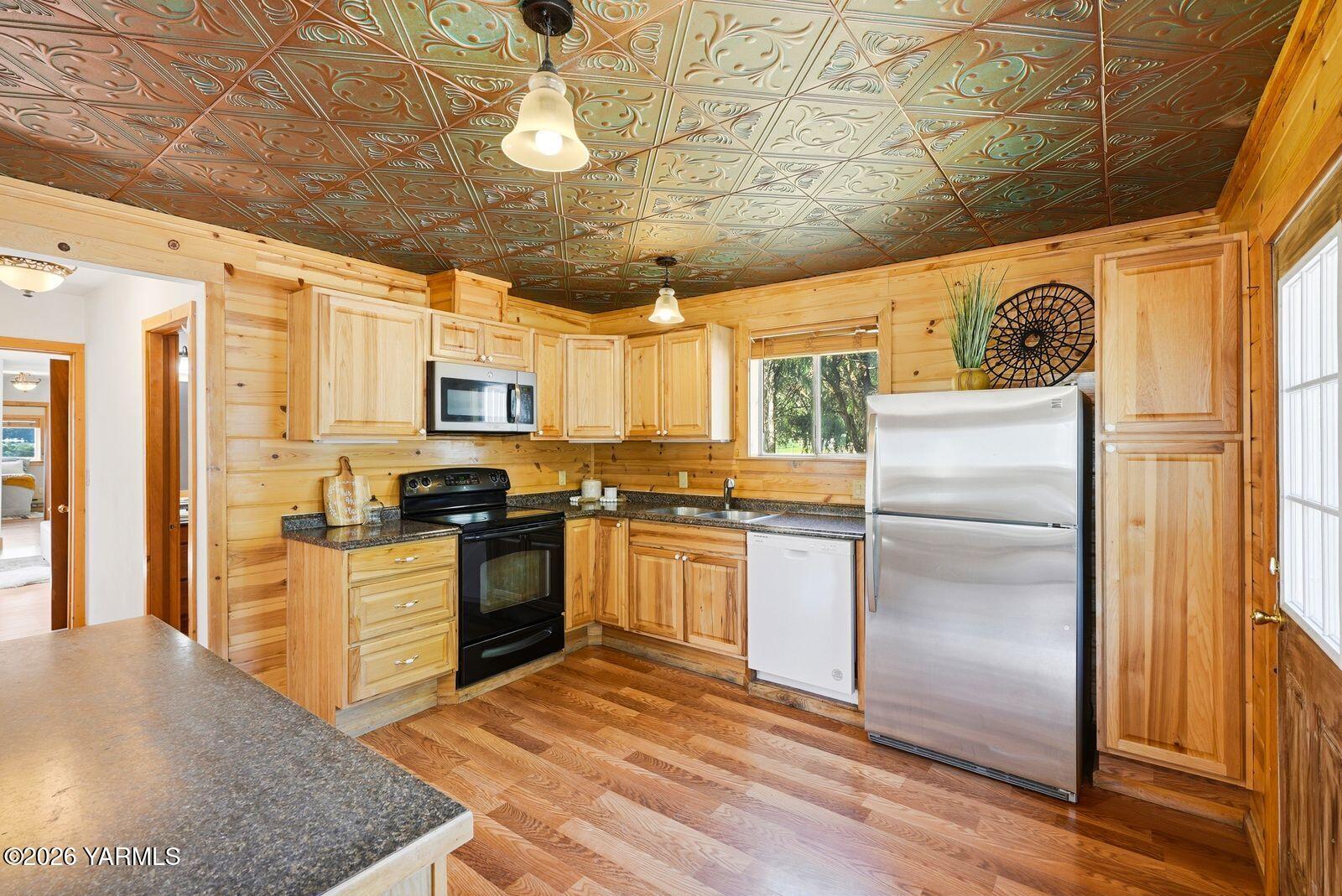 3780 Nile Road Naches, WA 98937 - Photo 10 of 43 a kitchen with stainless steel appliances granite countertop a refrigerator a stove a sink dishwasher and a refrigerator with white cabinets