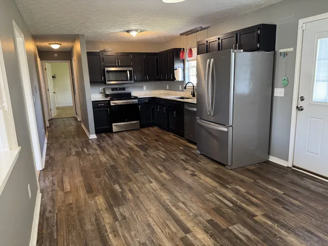 a view of a kitchen from the hallway