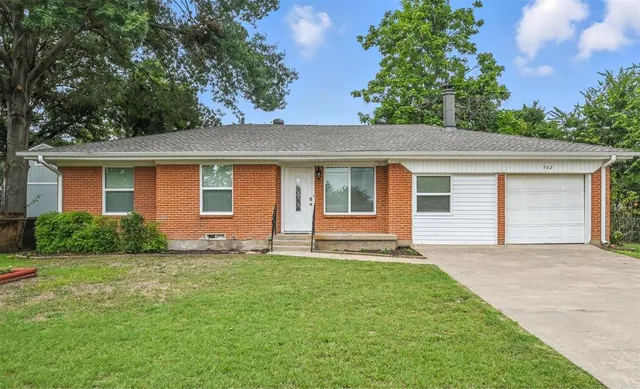 front view of a house with a yard