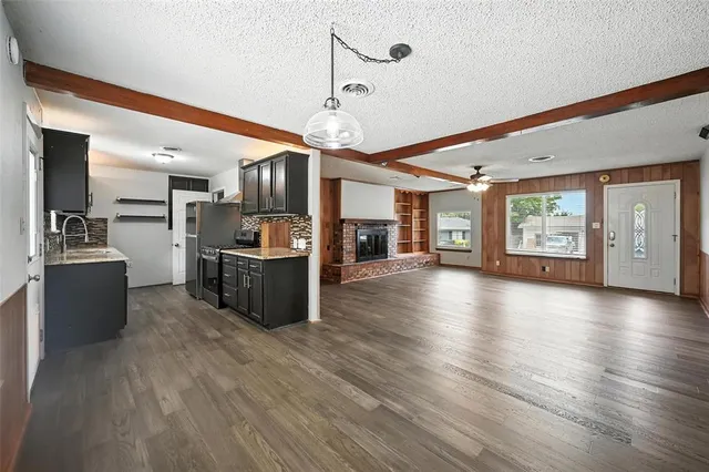 a view of a kitchen with refrigerator stove and wooden floor