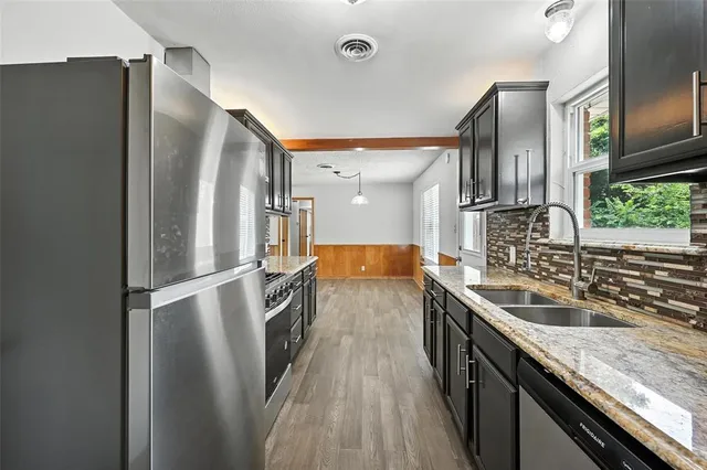a kitchen with a sink refrigerator and microwave