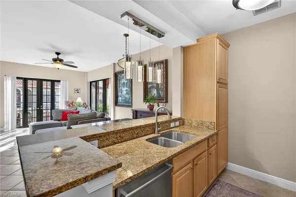 a kitchen with sink refrigerator and window