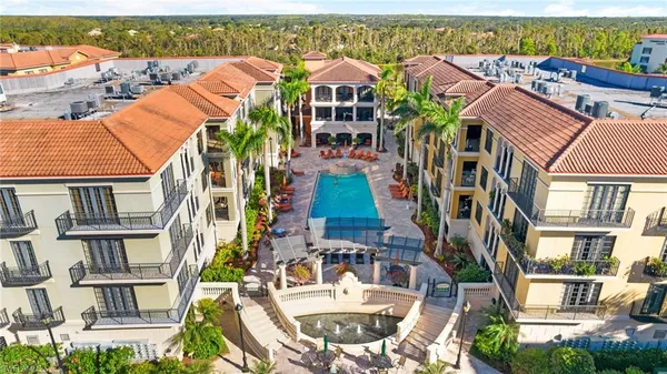 an aerial view of residential houses with outdoor space and ocean view