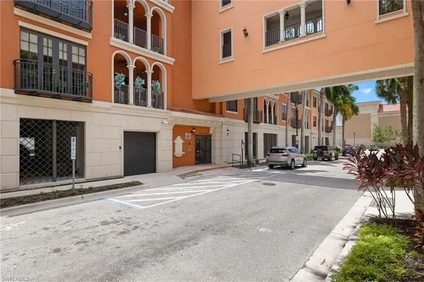 a front view of a building with a yard and a garage