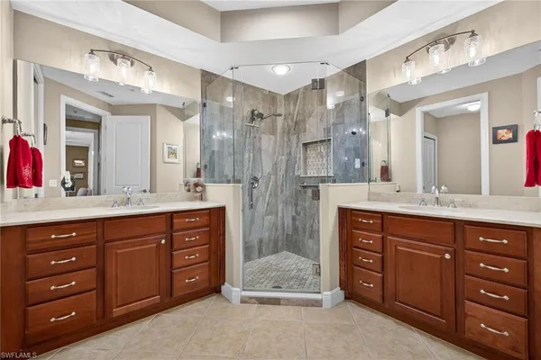 a spacious bathroom with a granite countertop double vanity sink mirror and