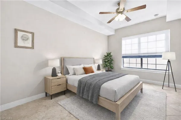 a bedroom with a bed and a large window