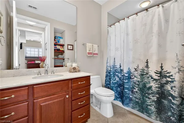 a spacious bathroom with a toilet sink and mirror