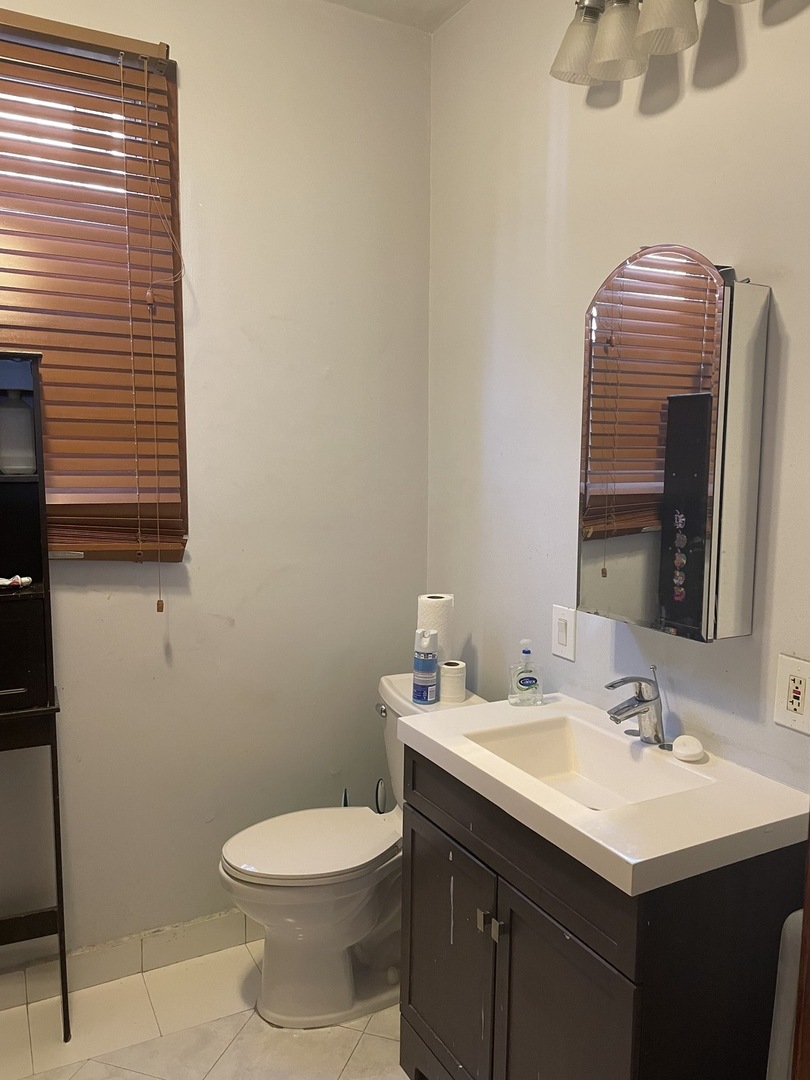 6335 Cermak Road Berwyn, IL 60402 - Photo 6 of 6 a bathroom with a sink a toilet and mirror