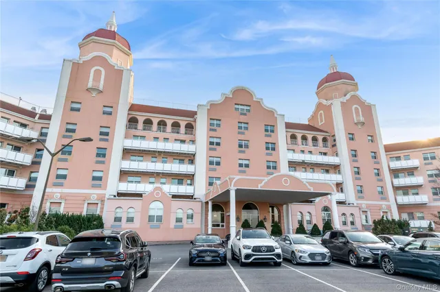a couple of cars parked in front of a building