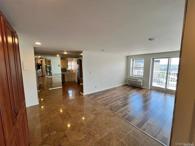 a view of a big room with windows and chandelier