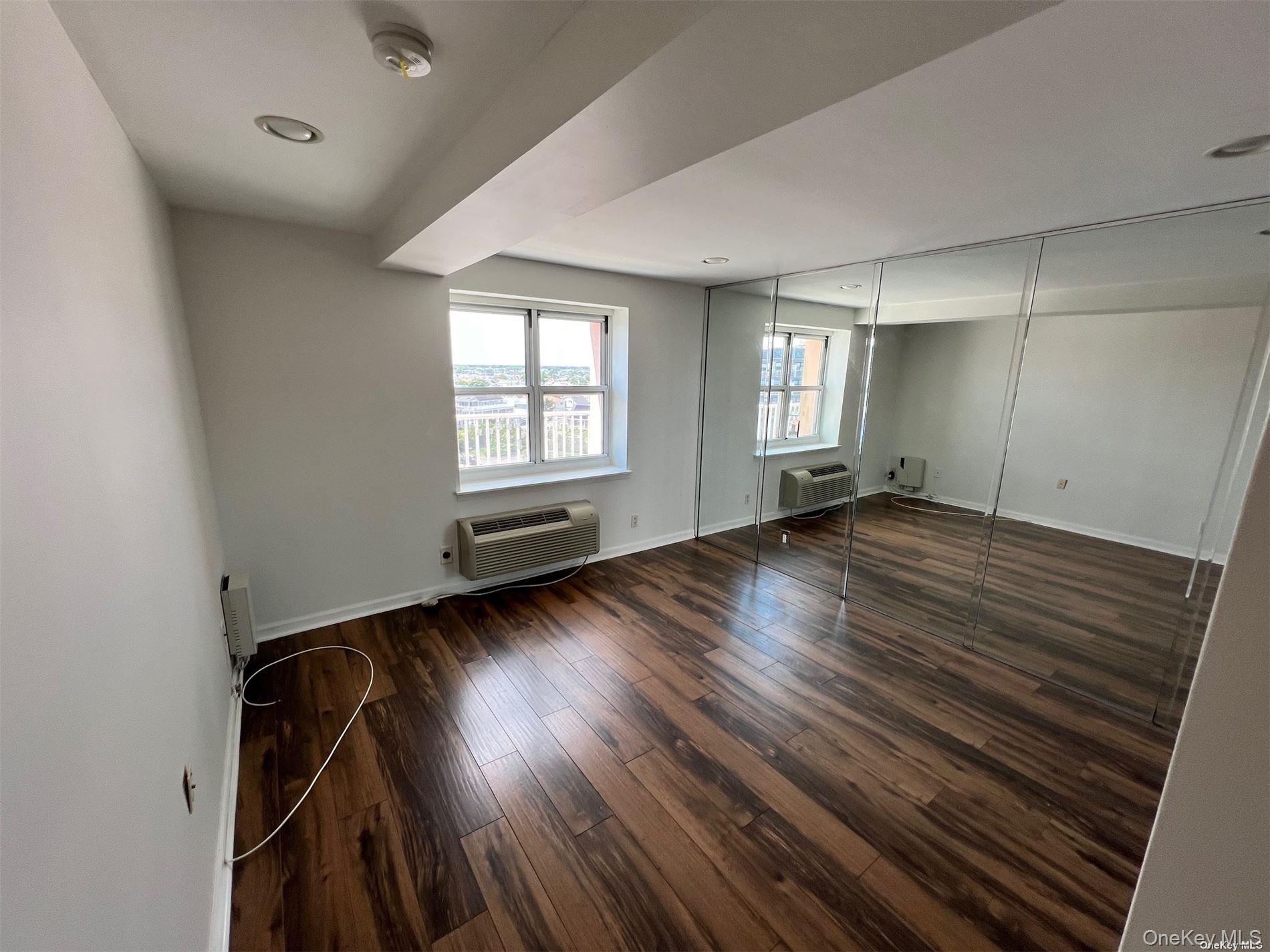 2 Richmond Road, Unit PH 6R Lido Beach, NY 11561 - Photo 12 of 19 an empty room with wooden floor and windows