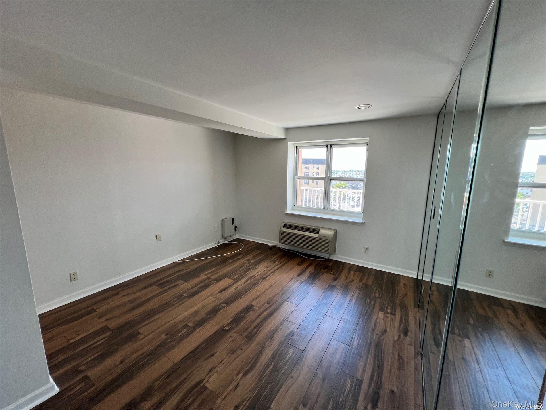 2 Richmond Road, Unit PH 6R Lido Beach, NY 11561 - Photo 13 of 19 an empty room with wooden floor and windows