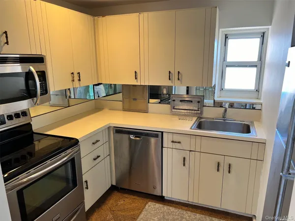 a kitchen with a sink stove and cabinets