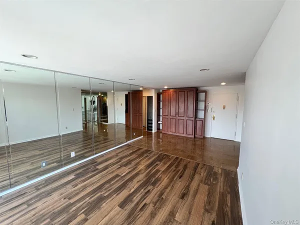 a view of a room with wooden floor and fence