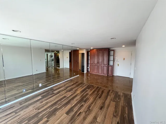 a view of a room with wooden floor and fence