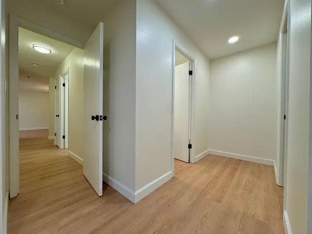 a view of a hallway with wooden floor