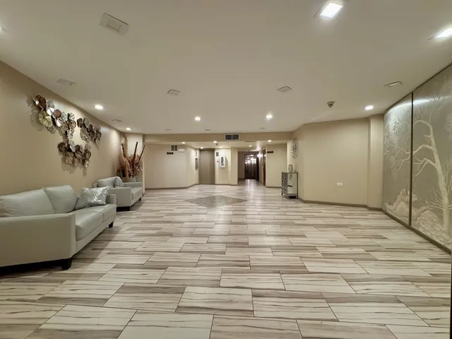 a large room with lots of white furniture