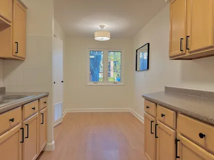 an empty room with cabinets and wooden floor