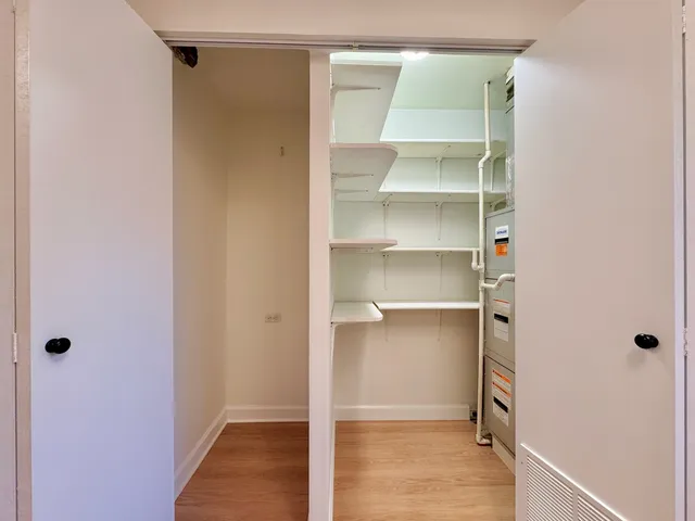a view of walk in closet with empty racks