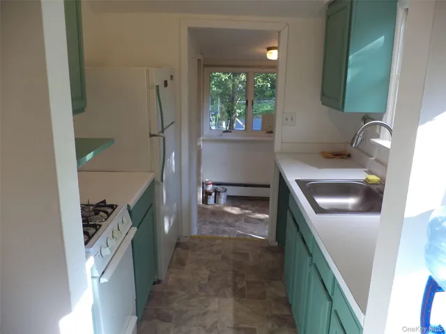 a kitchen with a sink stove and refrigerator