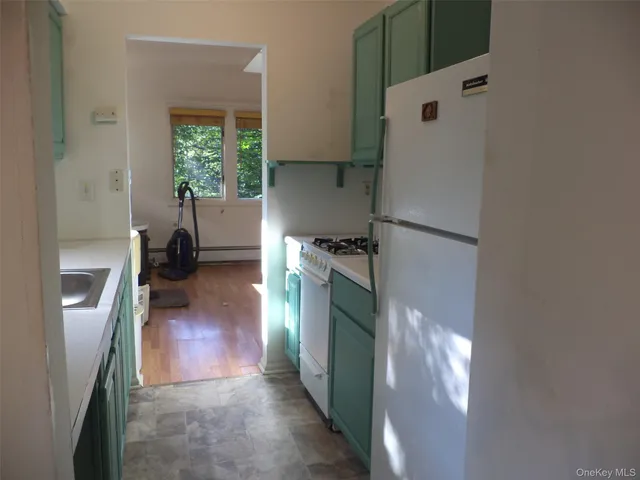 a kitchen with a refrigerator and a stove