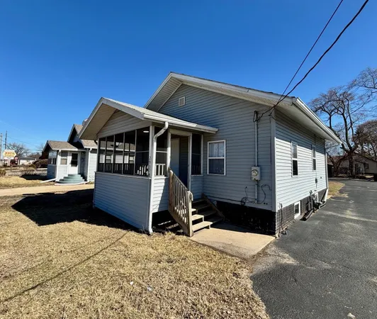 a kitchen that has a sink and wooden cabinets