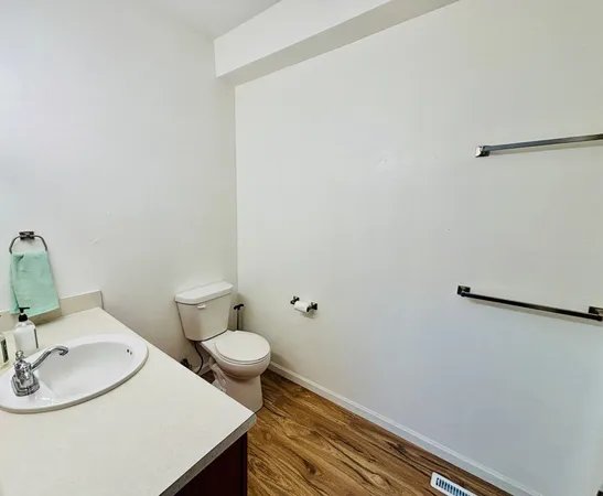 a bathroom with a sink a toilet and a mirror