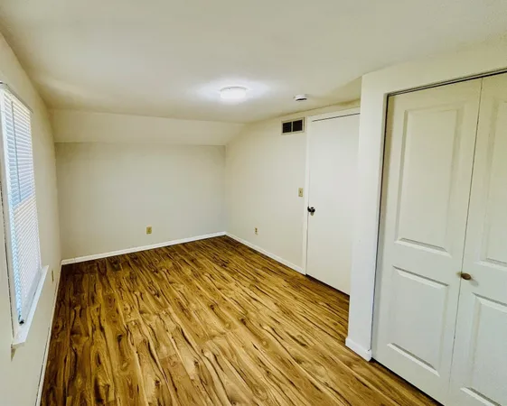 a view of a room with wooden floor and bathroom