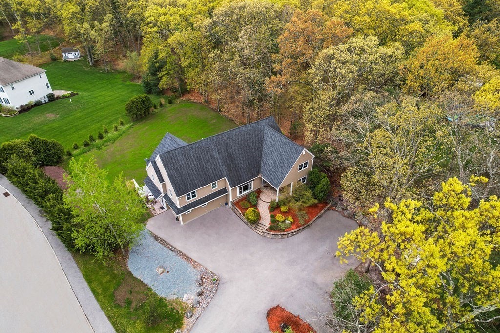 an aerial view of a garden with chairs