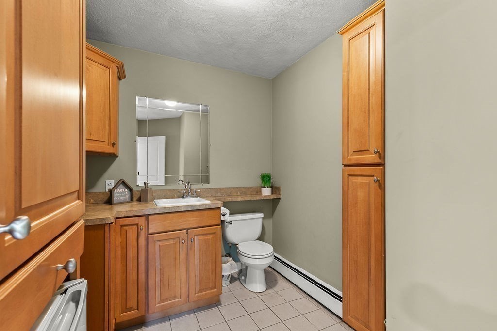732 Hickory Road North Attleboro, MA 02760 - Photo 11 of 41 a bathroom with a granite countertop toilet a sink and a mirror