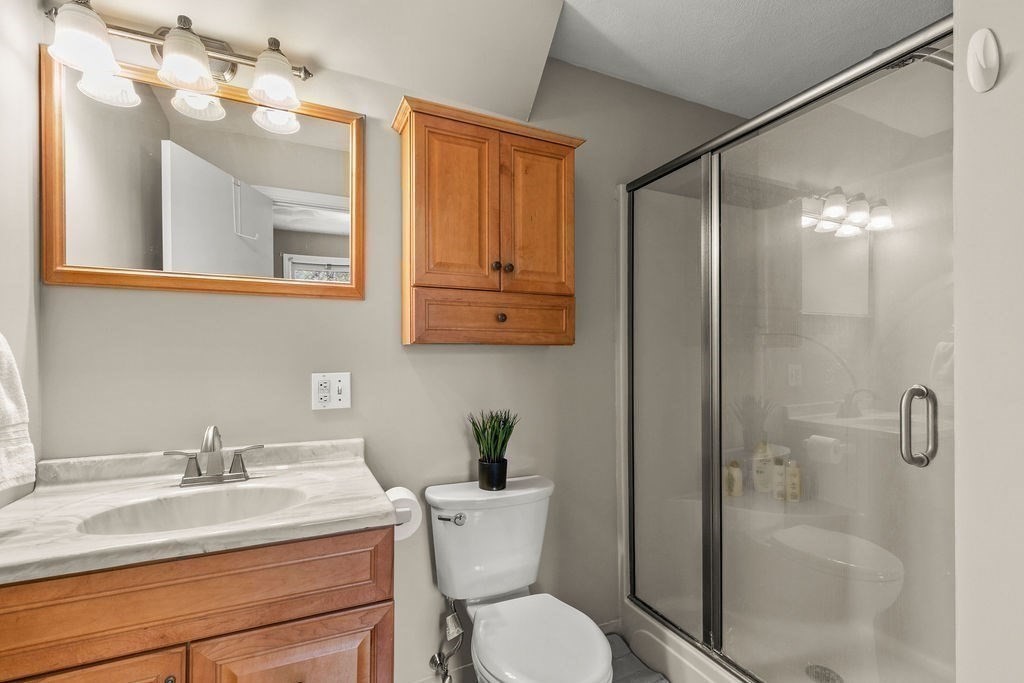 732 Hickory Road North Attleboro, MA 02760 - Photo 14 of 41 a bathroom with a sink toilet a mirror and shower