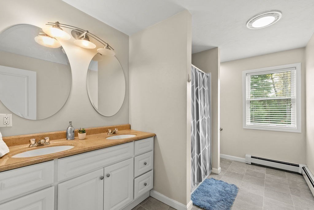 732 Hickory Road North Attleboro, MA 02760 - Photo 20 of 41 a bathroom with a double vanity sink and a mirror