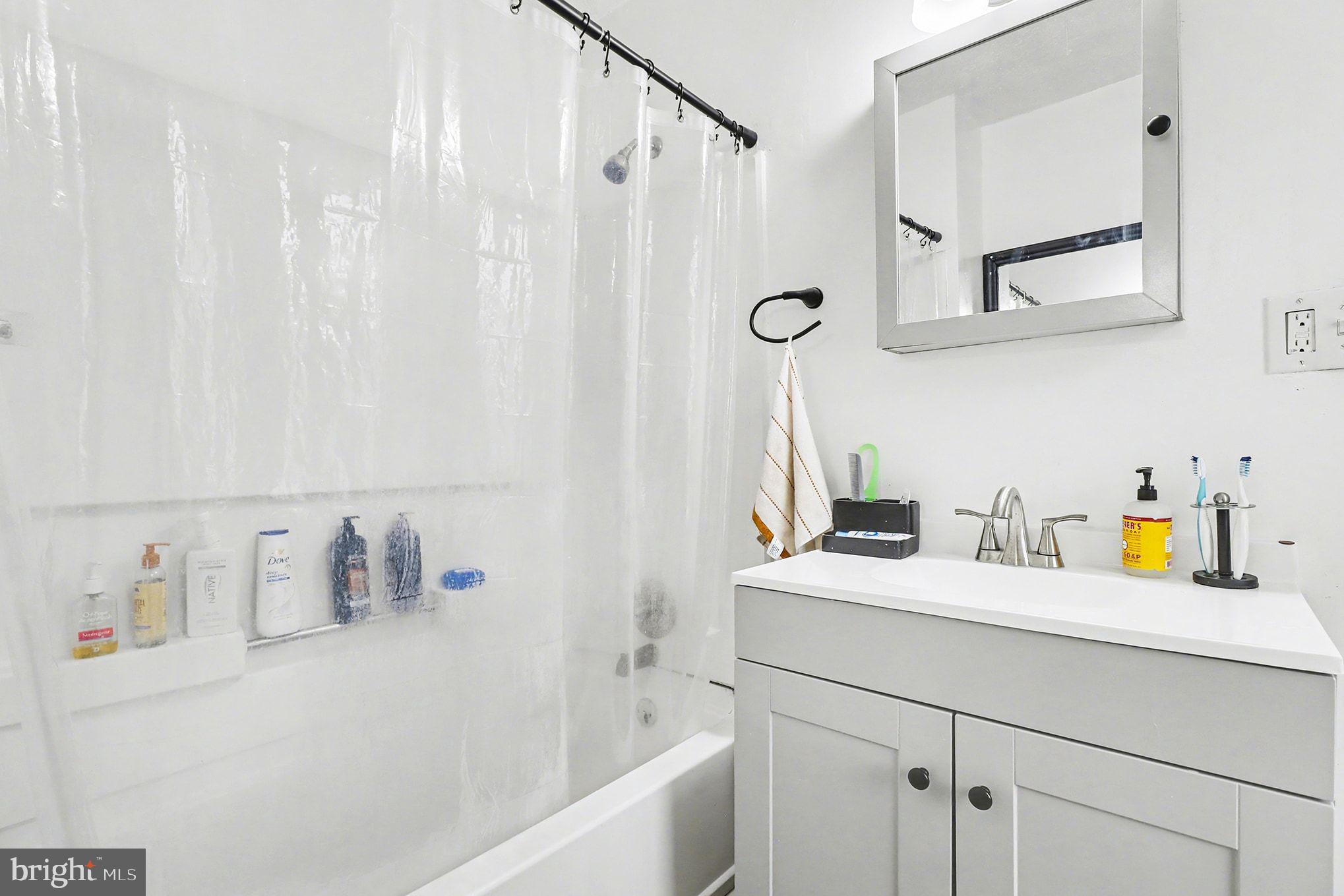 412 Locust Street Lancaster, PA 17602 - Photo 13 of 32 a bathroom with a sink vanity granite tub and a shower