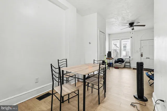 a view of a livingroom with workspace and a window