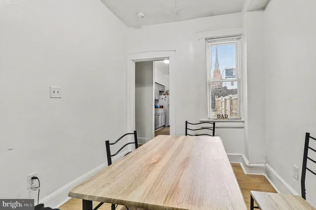 a view of a livingroom with workspace and a window