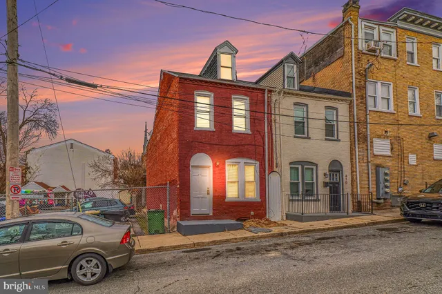 a front view of a building with parking space