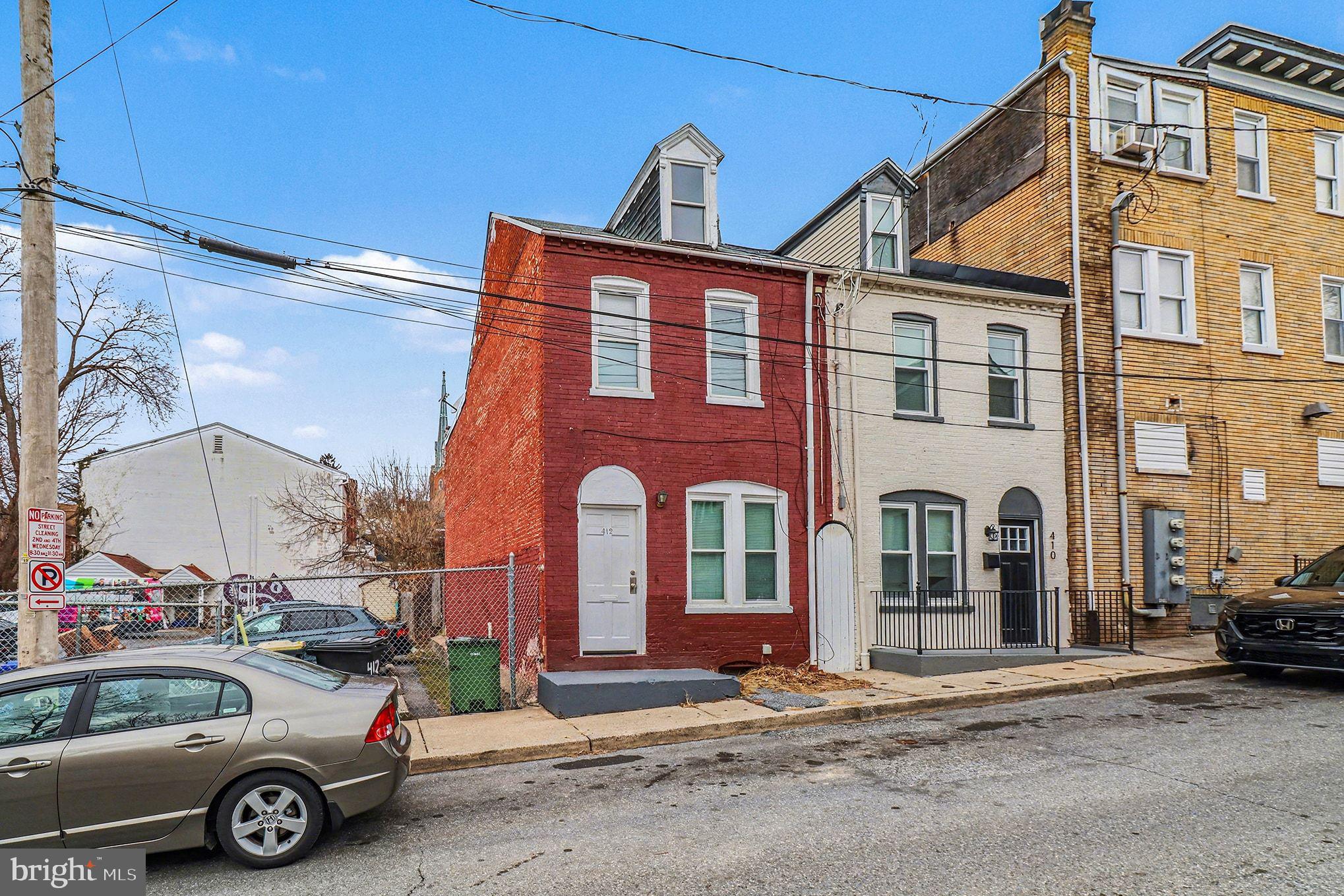 412 Locust Street Lancaster, PA 17602 - Photo 3 of 32 a front view of a building with parking space
