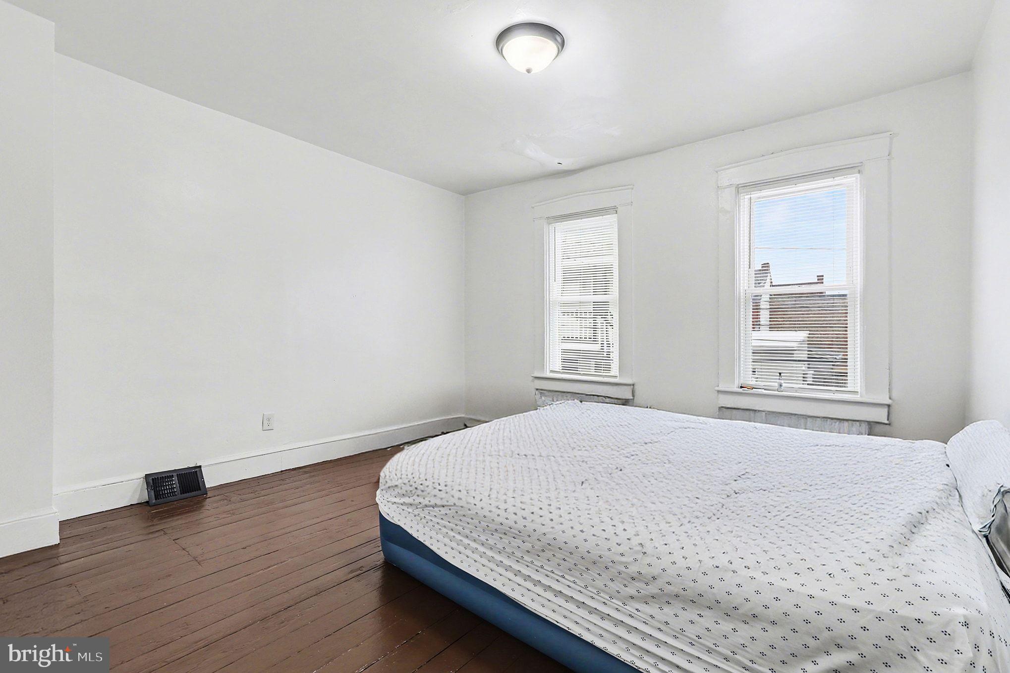 412 Locust Street Lancaster, PA 17602 - Photo 7 of 32 a bedroom with a bed and a window