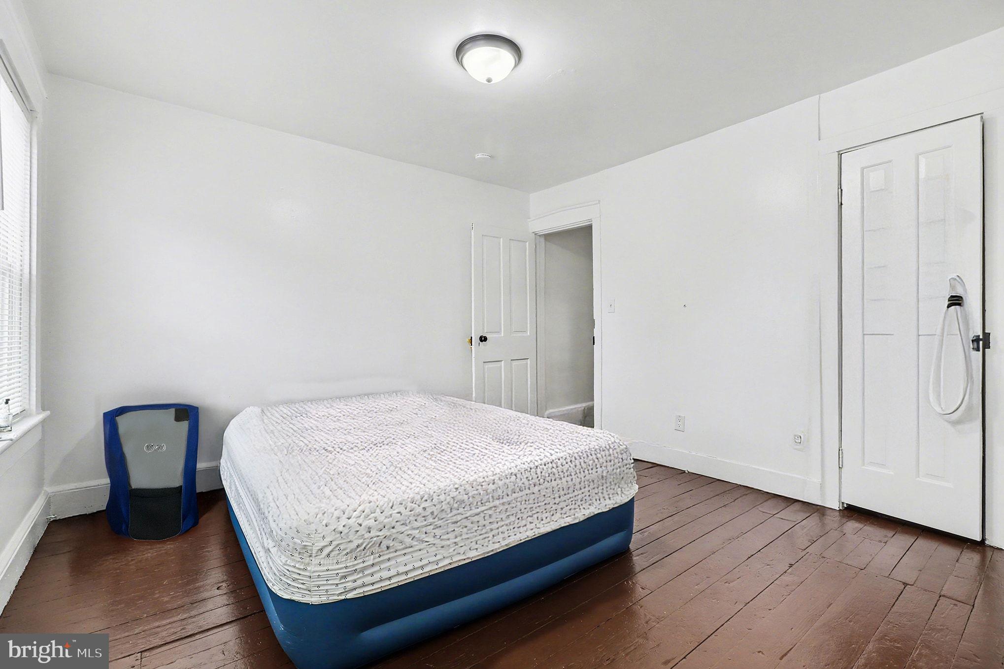 412 Locust Street Lancaster, PA 17602 - Photo 8 of 32 a bedroom with a bed and wooden floor