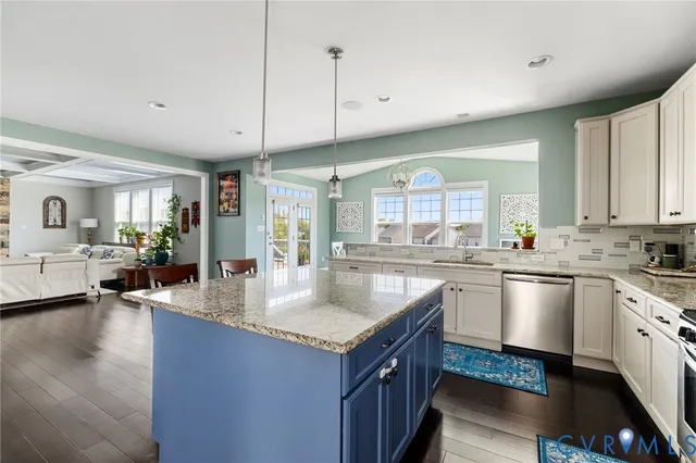 a view of a dining room with furniture large windows and wooden floor