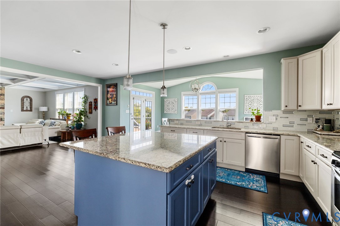 12008 Stable Ridge Terrace Glen Allen, VA 23059 - Photo 11 of 38 a kitchen with granite countertop a sink a counter top space and living room view