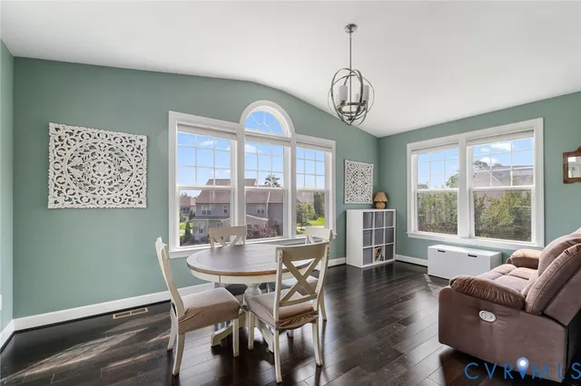 a living room with furniture and wooden floors